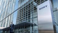 This file photo taken on October 31, 2022 shows a man walking past the Sony logo outside the company's headquarters in Tokyo. Photo by Richard A. Brooks / AFP