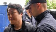 File photo: South Korean cryptocurrency entrepreneur, co-founder of Terraform Labs (Terra Luna), Do Kwon (L), is taken to court in Podgorica on May 11, 2023, following his arrest on March 24 at the Montenegrin capital's international airport. (Photo by SAVO PRELEVIC / AFP)

