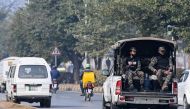 Paramilitary personnel patrolling a street ride a vehicle in Islamabad on January 22, 2024. (Photo by Farooq Naeem / AFP)
