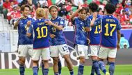 Japan's players celebrate after their second goal during the Qatar 2023 AFC Asian Cup Group D football match between Japan and Indonesia at al-Thumama Stadium in Doha on January 24, 2024. (Photo by HECTOR RETAMAL / AFP)
