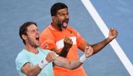 India's Rohan Bopanna (R) and Australia's Matthew Ebden celebrate after victory against Italy's Simone Bolelli and Andrea Vavassori during their men's doubles final match on day 14 of the Australian Open tennis tournament in Melbourne on January 27, 2024. (Photo by WILLIAM WEST / AFP)