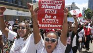 Activists shout as they demonstrate in the Central Business District against an alarming rise in murders of young women in Nairobi on January 27, 2024. (Photo by Tony KARUMBA / AFP)
