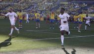 Real Madrid's French midfielder #18 Aurelien Tchouameni celebrates with teammates after scoring his team's second goal during the Spanish league football match between UD Las Palmas and Real Madrid CF at the Gran Canaria stadium in Las Palmas de Gran Canaria on January 27, 2024. (Photo by DESIREE MARTIN / AFP)
