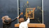 This image grab taken from AFPTV shows two environmental activists hurling soup at Leonardo Da Vinci's 