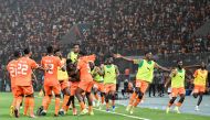 Ivory Coast's forward #14 Oumar Diakite (C) takes his jersey off as he celebrates with teammates after scoring his team's second goal during the Africa Cup of Nations (CAN) 2024 quarter-final football match between Mali and Ivory Coast at the Stade de la Paix in Bouake on February 3, 2024. (Photo by Issouf SANOGO / AFP)
