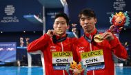 Gold medallists China's Wang Zongyuan and Long Daoyi pose during the medal ceremony of the final of the men's 3m springboard synchro diving event during the 2024 World Aquatics Championships at Hamad Aquatics Centre in Doha on February 4, 2024. (Photo by Oli SCARFF / AFP)
