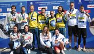 Silver-medallists team Italy, gold-medallists team Australia and bronze-medallists team Hungary pose on the podium with their medals after the final of the mixed 4X1500m relay open water swimming event. PICS: AFP