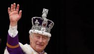 Britain's King Charles III wearing the Imperial state Crown, waves from the Buckingham Palace balcony after viewing the Royal Air Force fly-past in central London on May 6, 2023, after his coronation. Photo by Stefan Rousseau / POOL / AFP

