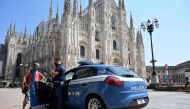 (Files) A police car stands in front of the Cathedral (Duomo di Milano) in Milan on August 12, 2020. (Photo by Miguel Medina / AFP)