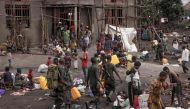 Congolese army soldiers walk along the side of the Bulengo camp a few kilometres from the centre of Goma, on February 16, 2024. . (Photo by Guerchom Ndebo / AFP)