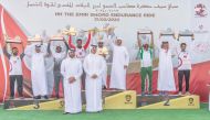 H E Sheikh Thani bin Hamad Al Thani poses for a picture with the winners of the H H the Amir Sword Endurance Ride.