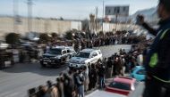 (Files) Spectators watch modified cars compete in a drag race along a street during a car racing event in Kabul on February 16, 2024. (Photo by Wakil Kohsar / AFP)