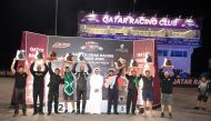 Qatar Racing Club Director Sheikh Jabor bin Khaled Al Thani poses with the champions of the respective event categories at the conclusion of the 2024 Arabian Drag Racing League season. 