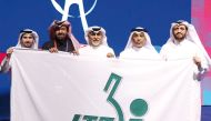 QTAA President Khalil Al Mohannadi (second right)  and members of Qatar delegation pose for a photo after receiving the flag.   