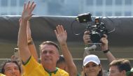 Former Brazilian President Jair Bolsonaro greets supporters next to his wife Michelle Bolsonaro during a rally in Sao Paulo, Brazil, on February 25, 2024, to reject claims he plotted a coup with allies to remain in power after his failed 2022 reelection bid. (Photo by Nelson Almeida / AFP)