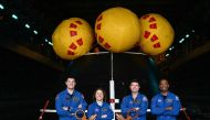 (From left) Canadian Space Agency (CSA) astronaut Jeremy Hansen, NASA Astronaut Christina Koch, NASA Astronaut Reid Wiseman, and NASA Astronaut Victor J. Glover stand for a photograph in front of the Orion crew module test capsule in the well deck aboard the USS San Diego (LPD-22) at Naval Base San Diego following the Underway Recovery Test 11 in San Diego, California on February 28, 2024. (Photo by Patrick T. Fallon / AFP)