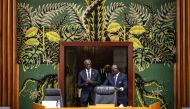 President of the National Assembly, Amadou Mame Diop (L) clasps his hands together as he enters the room at the start of the examination of the proposed amnesty law in Dakar on March 6, 2024. (Photo by JOHN WESSELS / AFP)
