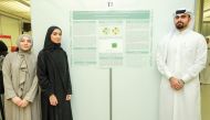 From left: WCM-Q pre-medical students Minatullah Al Ani, Amna Ali and Mohammed Shaikah with their research poster. 
