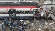 Bodies of victims are evacuated after a train exploded at the Atocha train station in Madrid, on March 11, 2004. Photo by Pierre-Philippe MARCOU / AFP