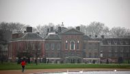 A jogger runs past Kensington Palace in London on March 11, 2024. (Photo by HENRY NICHOLLS / AFP)
