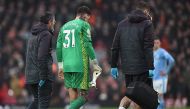Manchester City's Brazilian goalkeeper #31 Ederson leaves the pitch after being substituted off injured during the English Premier League football match between Liverpool and Manchester City at Anfield in Liverpool, north west England on March 10, 2024. (Photo by Paul ELLIS / AFP)
