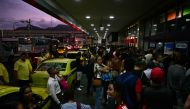 People wait to enter to the Novo Rio bus terminal after the gunman who was holding passengers hostage surrendered in Rio de Janeiro, Brazil on March 12, 2024. (Photo by Pablo PORCIUNCULA / AFP)
