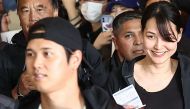 Mamiko Tanaka (R), wife of Los Angeles Dodgers Shohei Ohtani (L), arrives with the baseball team's players at Incheon International Airport in Incheon on March 15, 2024, ahead of the 2024 MLB Seoul Series baseball games between Los Angeles Dodgers and San Diego Padres. Photo by YONHAP / AFP