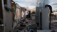 Residents clean up after a tornado ripped through town on March 15, 2024 in Winchester, Indiana. At least three people have been reported killed after a series of tornadoes ripped through the midwest yesterday. (Photo by SCOTT OLSON / GETTY IMAGES NORTH AMERICA / Getty Images via AFP)
