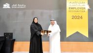 QIIB’s Director of Recruitment and Employee Affairs, Samah Nasser Al Dhafiri receives the distinguished shield of honor from the President of Qatar University, Dr. Omar al Ansari.