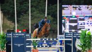 Hamad Nasser Al Qadi guides Happy Tina over a fence.