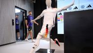 Germany's forward Deniz Undav (L) and Germany's forward Niclas Fuellkrug arrive for a press conference past a mannequin wearing the new German kit made by Adidas after a training session of the German national football team on March 21, 2024 in Frankfurt am Main, western Germany, in preparation of the team's international friendly football matches against France and the Netherlands. (Photo by Kirill KUDRYAVTSEV / AFP)
