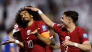 Qatar’s captain Akram Afif (left) celebrates with Ahmed Al Rawi after scoring his team’s third goal against Kuwait, yesterday. AFP