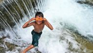 A child puts his swimming goggles on before jumping in a public pool of spring water in Japakeh, Indonesia's Aceh province on March 22, 2024, during the World Water Day. (Photo by Chaideer Mahyuddin / AFP)