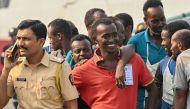 Accused Somali pirates wait to be transferred to police custody at the Indian naval dockyard in Mumbai on March 23, 2024. (Photo by Indranil Mukherjee / AFP)