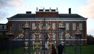 People stop by the gates of Kensington Palace in London on March 22, 2024. (Photo by Henry Nicholls / AFP)
 