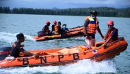 Members of the National Search and Rescue Agency (BASARNAS) search for missing Rohingya refugees after 69 refugees were rescued from their overturned boat in the sea near Calang, West Aceh, on March 23, 2024. (Photo by Zahlul AKBAR / AFP)