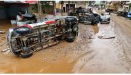 This handout picture released by the Espirito Santo State Government shows vehicles overturned on a street covered by mud after heavy rains hit the southeastern region of Brazil on March 24, 2024, in Mimoso do Sul, Espirito Santo State. (Photo by Wender / ESPIRITO SANTO STATE GOVERNMENT / AFP)