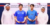 Secretary General of the Qatar Tennis, Squash, Padel and Badminton Federation Tareq Zainal (right) and Tournament Director Saad Al Mohannadi (left) with the finalists of PSA 2 QSF Satellite 2024 Tournament.