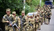 A military battalion patrols a community in Apopa, El Salvador, on October 11, 2023. Photo by Marvin RECINOS / AFP. 