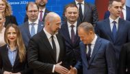 Ukraine's Prime Minister Denys Shmyhal (C) and Polish Prime Minister Donald Tusk (R) shakes hands during the family photo of the Ukrainian and Polish delegations during Polish-Ukraine Government Consultation at the Polish Prime Ministry office in Warsaw, March 28, 2024. Photo by Wojtek Radwanski / AFP.
 