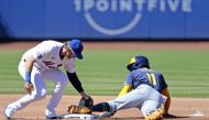 Jackson Chourio #11 of the Milwaukee Brewers steals second base under the tag attempt of Jeff McNeil #1 of the New York Mets during the top of the first inning in the home opener at Citi Field on March 29, 2024 in New York City. (Photo by Christopher Pasatieri / GETTY IMAGES NORTH AMERICA / Getty Images via AFP)