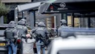 A man is arrested by members of the DSI special police forces in a cafe in Ede, on March 30, 2024. (Photo by Remko de Waal / ANP / AFP) 
