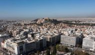 This aerial photograph taken on March 30, 2024 shows in the background Parthenon ancient temple on the top of the Acropolis hill in Athens. Photo by Aris MESSINIS / AFP