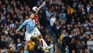 Manchester City's English midfielder #10 Jack Grealish (L) fights for the ball with Arsenal's French defender #02 William Saliba (R) during the English Premier League football match between Manchester City and Arsenal at the Etihad Stadium in Manchester, north west England, on March 31, 2024. (Photo by Darren Staples / AFP)
