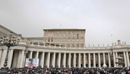 The crowd looks in direction of the window of the apostolic palace overlooking St. Peter's square during Pope Francis' Regina Coeli prayer on April 1st, 2024 in The Vatican. (Photo by Tiziana FABI / AFP)