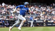 Cavan Biggio #8 of the Toronto Blue Jays hits a double during the fourth inning of the game against the New York Yankees during the home opener at Yankee Stadium on April 05, 2024 in New York City. (Photo by Dustin Satloff / GETTY IMAGES NORTH AMERICA / Getty Images via AFP)