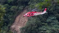A National Airborne Service Corps UH-60 helicopter flies past a section of landslide caused by the April 3 earthquake in Taroko National Park in Hualien on April 6, 2024. Photo by I-Hwa CHENG / AFP.