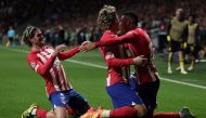 Atletico Madrid's Brazilian forward #12 Samuel Lino (right) celebrates with teammates after scoring his team's second goal during the UEFA Champions League quarter final first leg football match between Club Atletico de Madrid and Borussia Dortmund at the Metropolitano stadium in Madrid on April 10, 2024. (Photo by Thomas Coex / AFP)