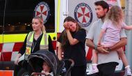 A woman cries as she comes out of the Westfield Bondi Junction shopping mall after a stabbing incident in Sydney on April 13, 2024. (Photo by David GRAY / AFP)
