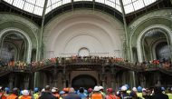 France's President Emmanuel Macron addresses employees in charge of the renovation work during his visit to Le Grand Palais, in Paris, on April 15, 2024, 100 days ahead of the Paris 2024 Olympic Games. Photo by Yoan VALAT / POOL / AFP